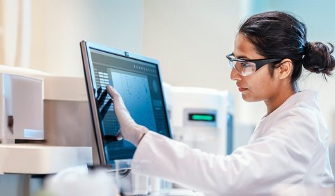 A person in a hazardous materials area looking at a computer screen.